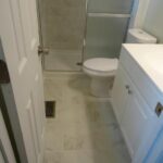 Tiles Work on the Bathroom Floor and Separator for Bath Area