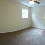 Two Windows on the New Paint Walls and Fan in the Bedroom