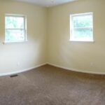 Double Door Closer, Carpet, and Two Windows in the Upgraded Bedroom