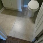 Tiles Work in the Bathroom, Cabinet and Toilet Seat