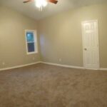 An Open Gate Towards Remodeled Room with Windows