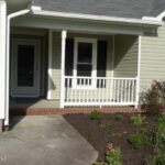 A Patio and Newly Grown Plants in the Front of the Home