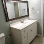 Designer Mirror, Towel Hanger, and Cabinets in the Bath