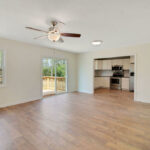 Living Room with Designer Fan and View of the Deck Outside