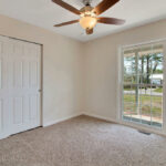 Bedroom with Wooden Sliding Door and Outside View from Window