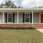 Patio in the Front and Colorful Flowers in the Front Yard