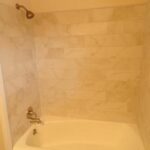 Upgraded Bath with New Fixtures, Bathtub, and Tiles on Wall