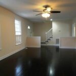 Refinished Floor, Divider, Stairs with Railing, and Fan with Lights