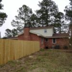 Red Brick Home, Chimney, and Fenced Premises