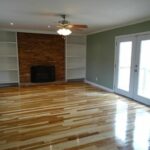 Spacious Living Area with Brick Fireplace and Shelves in the Wall