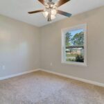 Empty Room View with Power Sockets, Flooring, and Windows