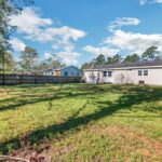 Fenced Home, Trees, and Vegetation Around the Home