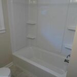 Remodeled Bathtub with Shelves for Bathroom Essentials