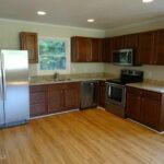 L Shaped Kitchen with Granite Platforms and Cabinets