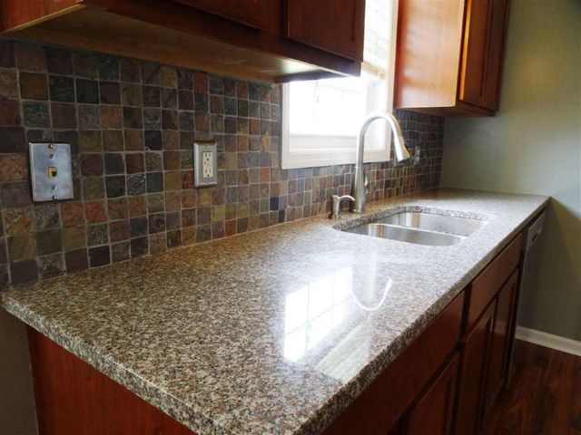 Drop Down Faucet with Concrete Platform in a Kitchen