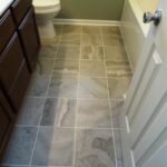 Tile Work on the Floor in the Bathroom and Toilet Seat