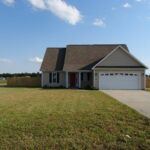 Trimmed Front yard, Garage and Driveway for The Home