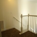 A Light on the Ceiling Above the Stairs and Railing