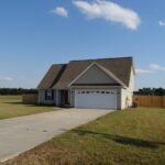 Driveway Towards Garage Door and Fenced Perimeter