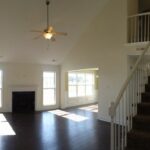 Living Area Remodeled with Fireplace, Floor, and Fan with Lights