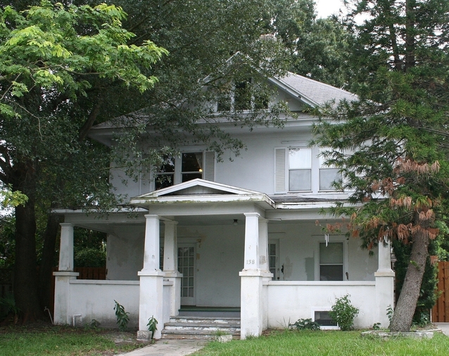 An Old Home with Stairs Shadowed with Trees