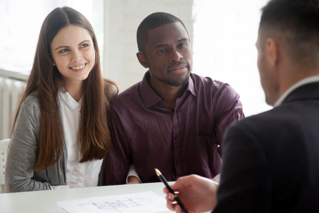 A Couple Talking to a Person in Suit