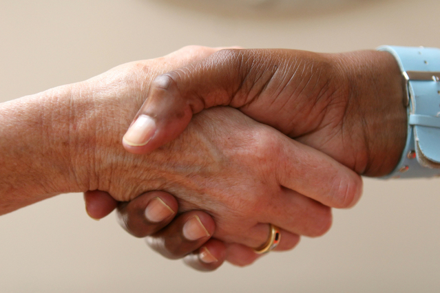 Man with Wristwatch and Woman with Ring Shaking Hands