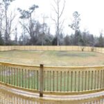 Huge Fenced Backyard with Dense Trees Beyond