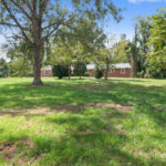 Exterior of the House with Trees, Grass, and View of the House