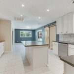 Quartz Counters in Kitchen, Sliding Door, and Lights On