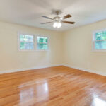 Fan with Lights on, Windows, and Original Hardwood Floor