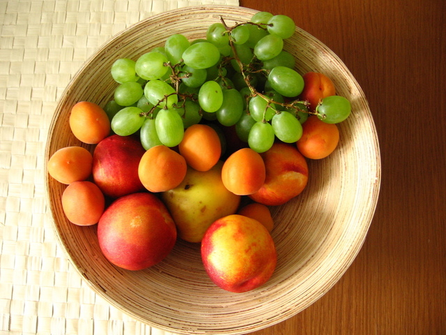 A Fruit Basket with Apples, Grapes, and Stone Fruits