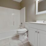 Two Designer Lights on a Mirror in the Redone Bath