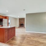 Brick Style Fireplace, Kitchen Island, and Redone Wall in the House