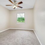 An Empty Room and View of Trees from A Closed Window