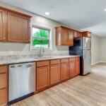 Open Kitchen with Island and Brick Style Fireplace