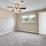 Remodeled Room With Designed Fan, Floor, and Two Gates