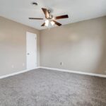 Empty Redeveloped Bedroom with a Designer Fan