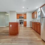 Wooden Cabinets, Appliances, and Serving Area Remodeled in a Kitchen